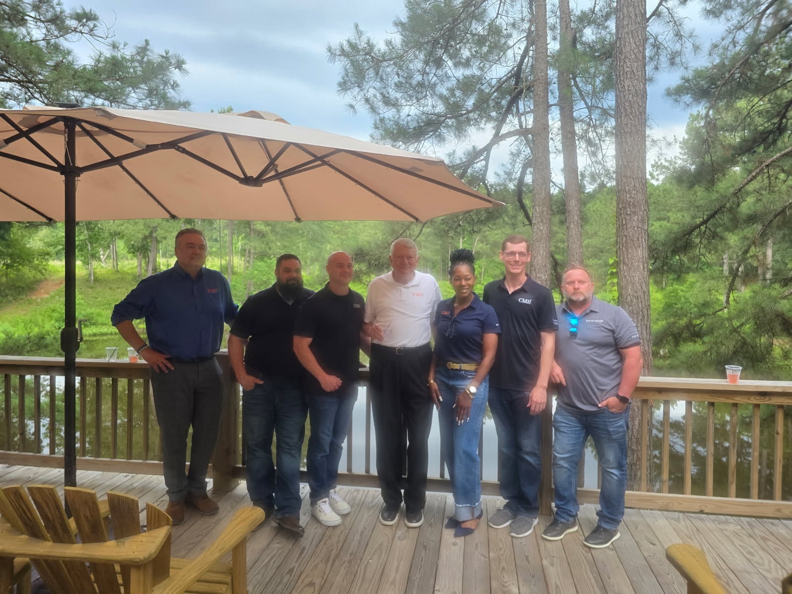 Group of people stand smiling.