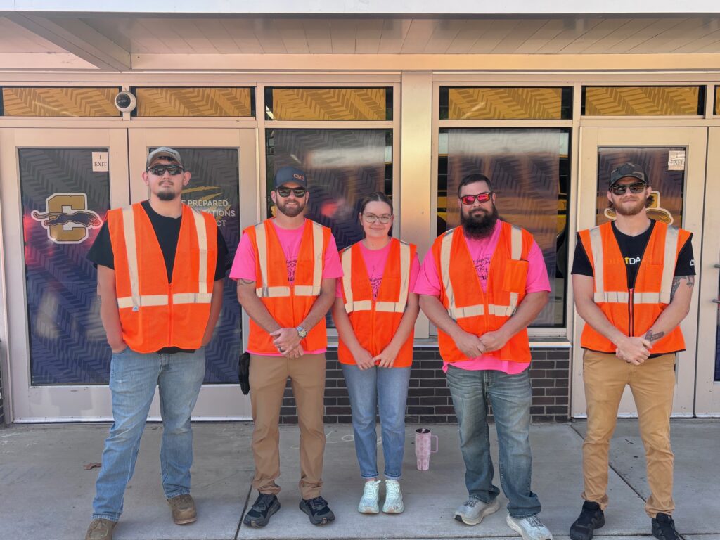 A group of people in orange vests 